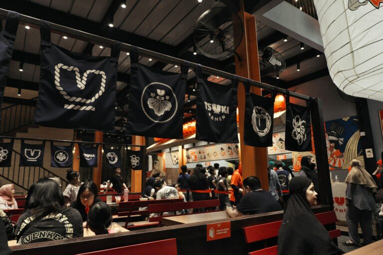A group of people sitting at tables in a restaurant.